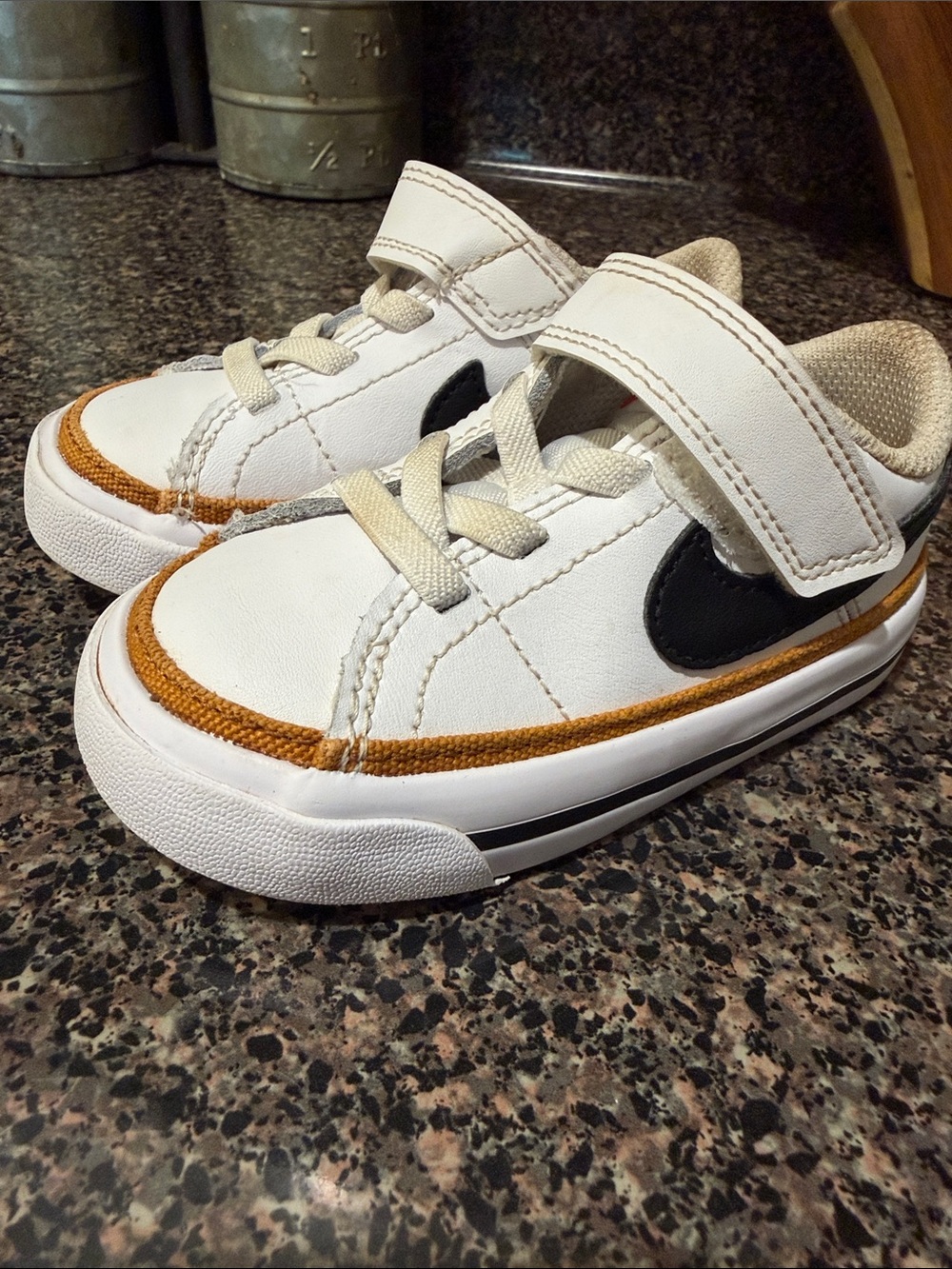 Nike Kids White Sneakers with Tan Accent and Black Swoosh